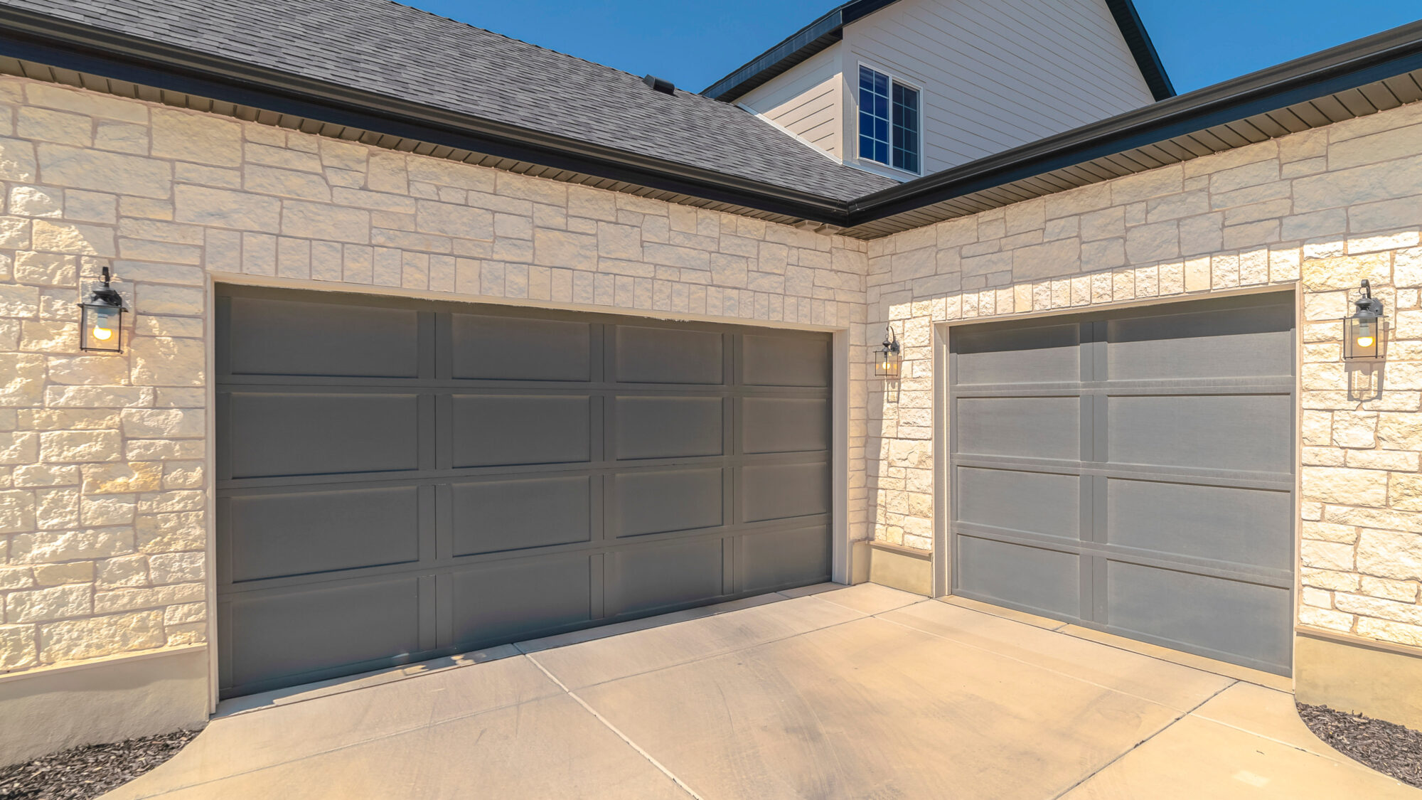 Technician performing garage door repair on a home in Fairview TX on a sunny North Texas day